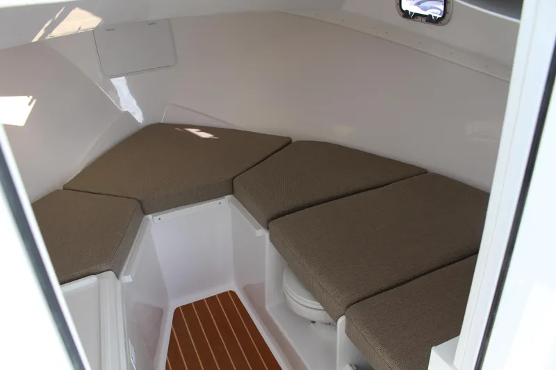 Slide: The Image of 2024 Steiger Craft 31 Miami cabin interior with cushioned seating and wooden flooring. - 31