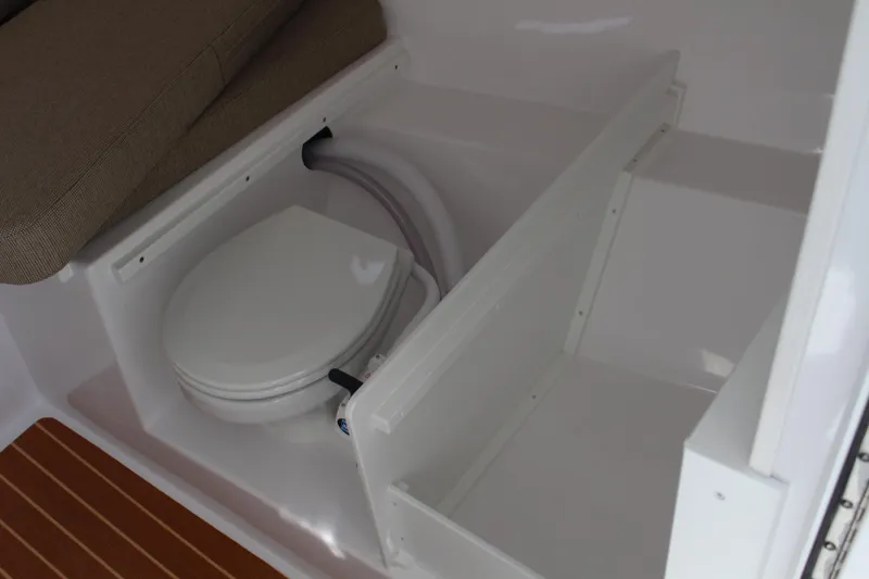 Slide: The Image of 2024 Steiger Craft 31 Miami boat interior with a compact marine toilet. - 34