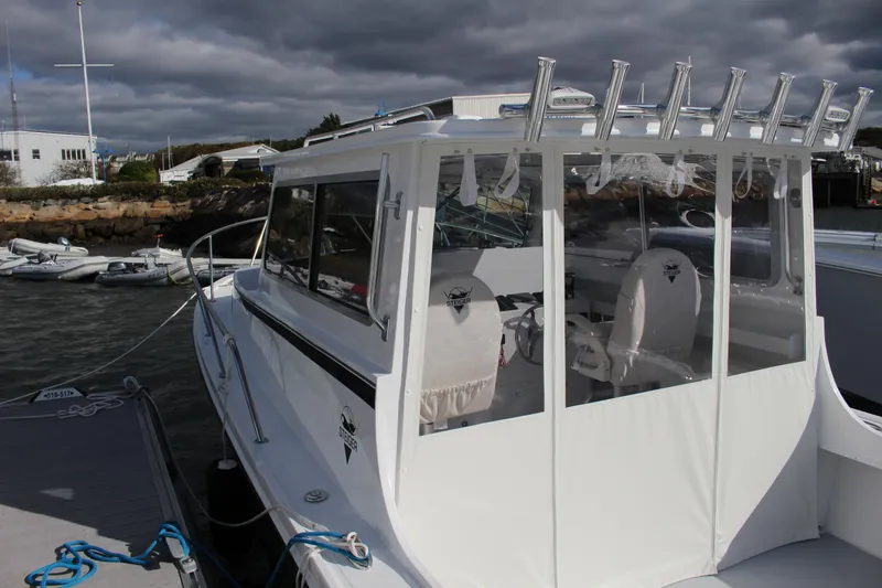 Slide: The Image of 2024 Steiger Craft 31 Miami boat docked at marina under cloudy sky. - 7