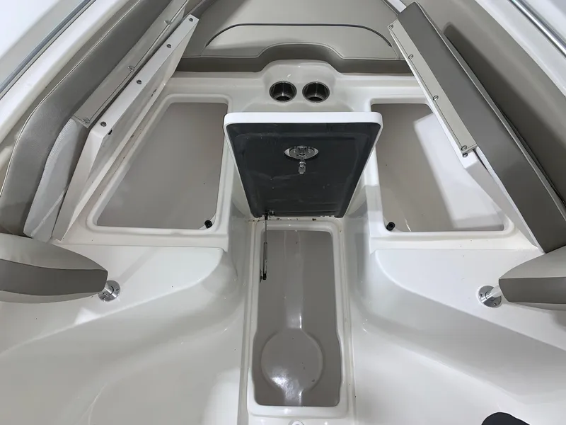 Slide: The Image of 2024 Key West 239 FS boat interior with storage compartments and cup holders. - 17