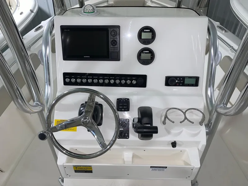 Slide: The Image of 2024 Key West 239 FS boat console with steering wheel, gauges, and electronic controls. - 8