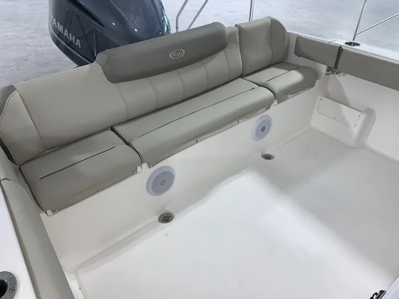 Slide: The Image of 2024 Key West 239 FS boat with cushioned seating and Yamaha engine. - 12