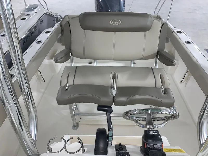 Slide: The Image of 2024 Key West 239 FS boat helm with dual seats and steering console. - 14