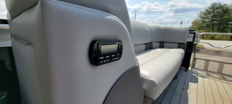 Slide: The Image of 2020 Ranger 2300LS boat with gray leather seating and built-in audio controls. - 10