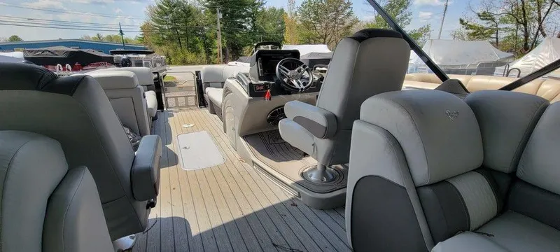 Slide: The Image of 2020 Ranger 2300LS boat interior with gray seating and steering console. - 11
