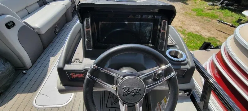 Slide: The Image of Steering console of a 2020 Ranger 2300LS boat with modern controls and seating. - 7