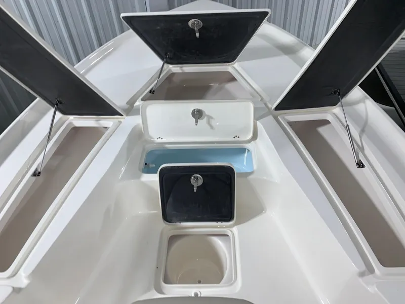 Slide: The Image of 2024 Key West 230 Bay Reef boat storage compartments open. - 13