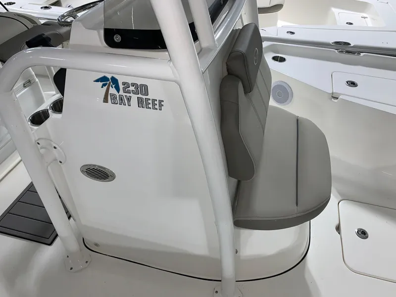 Slide: The Image of 2024 Key West 230 Bay Reef boat interior with seating and console. - 12