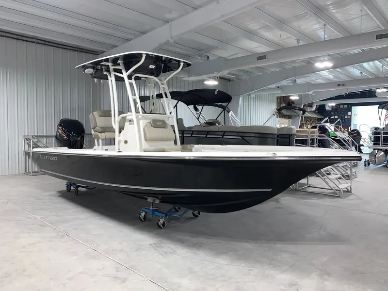 Slide: The Image of 2024 Key West 230 Bay Reef boat in showroom. - 2