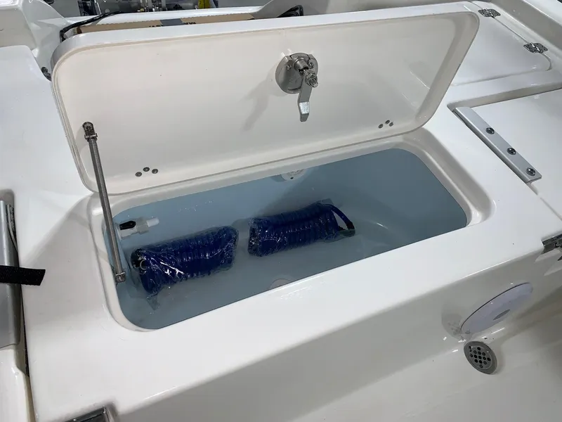 Slide: The Image of 2024 Key West 230 Bay Reef boat livewell with blue hoses. - 5