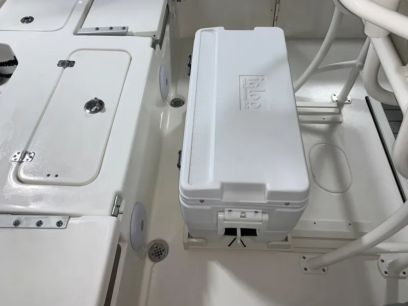 Slide: The Image of 2024 Key West 230 Bay Reef boat interior with storage compartments and cooler. - 8