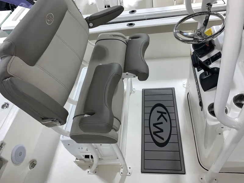 Slide: The Image of 2024 Key West 230 Bay Reef boat interior with helm and seating. - 9