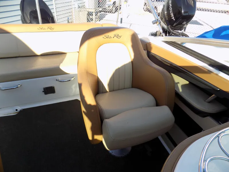 Slide: The Image of 2014 Sea Ray 220 Sundeck boat interior with tan and cream seating. - 9