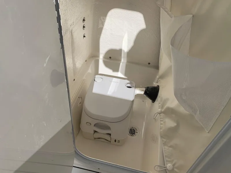 Slide: The Image of 2024 Key West 244 CC boat interior with portable toilet. - 20