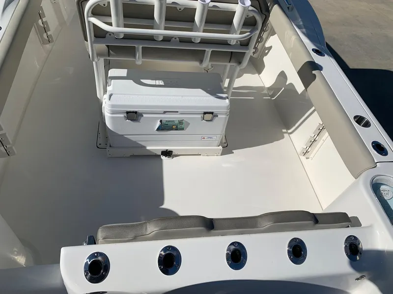 Slide: The Image of 2024 Key West 244 CC boat interior with cooler and seating. - 7
