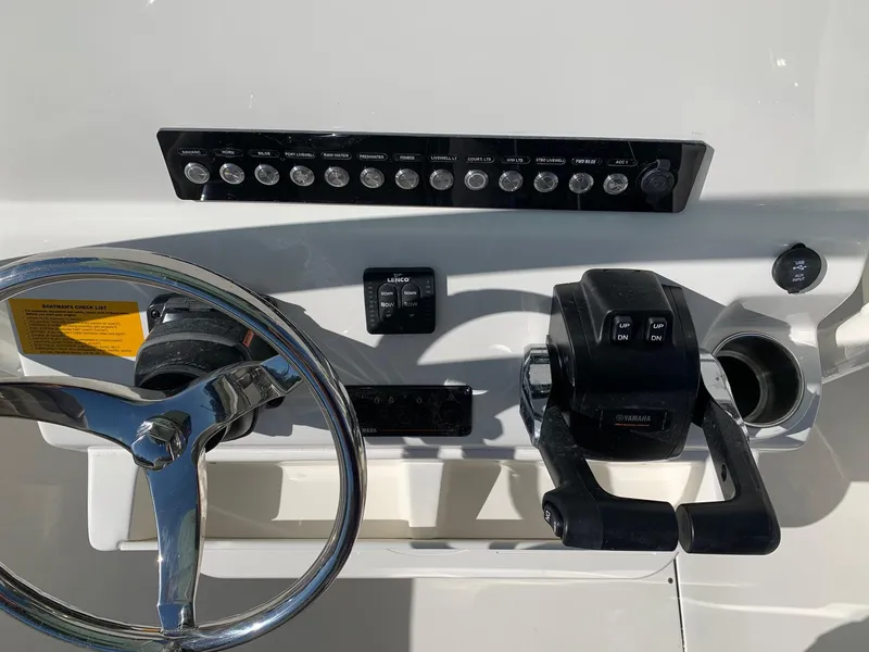 Slide: The Image of 2024 Key West 244 CC boat dashboard with steering wheel and controls. - 13