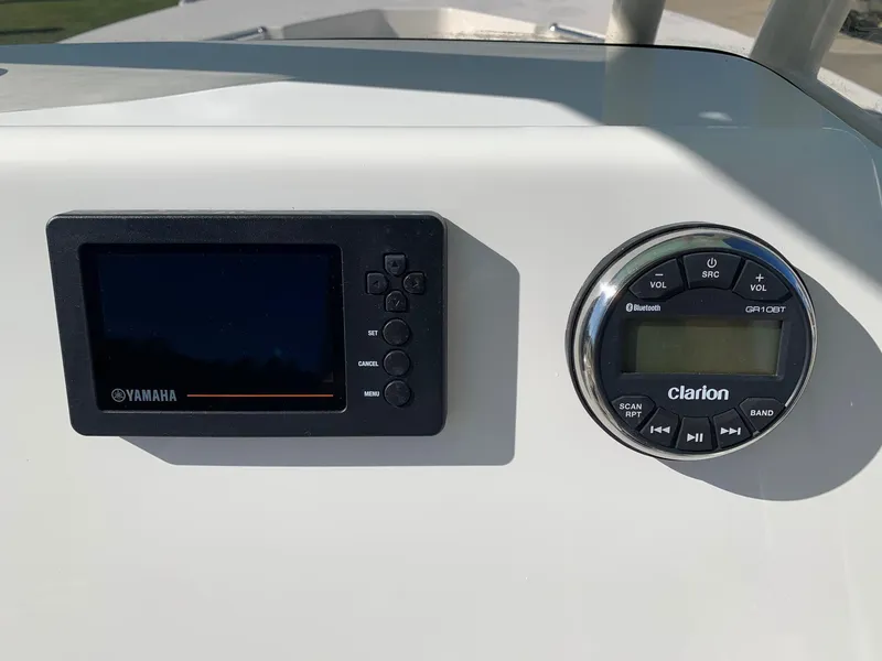Slide: The Image of Yamaha and Clarion controls on 2024 Key West 244 CC boat dashboard. - 14