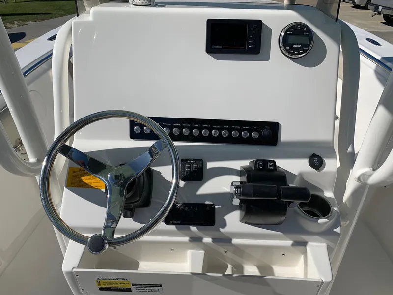 Slide: The Image of 2024 Key West 244 CC boat console with steering wheel and control panel. - 15