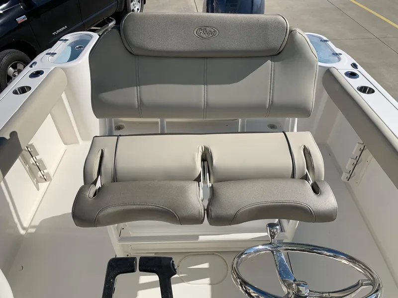 Slide: The Image of 2024 Key West 244 CC boat cockpit with dual seating and steering wheel. - 16