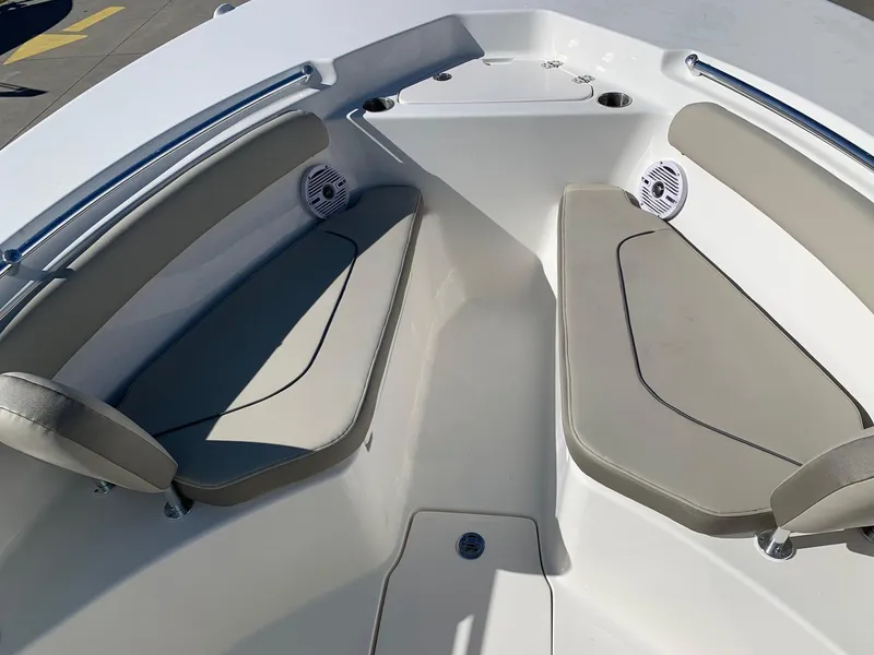 Slide: The Image of 2024 Key West 244 CC boat interior with cushioned seating and speakers. - 26