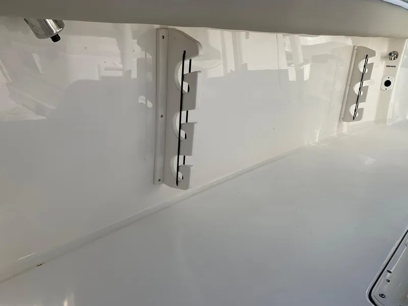 Slide: The Image of 2024 Key West 244 CC boat interior with rod holders. - 7