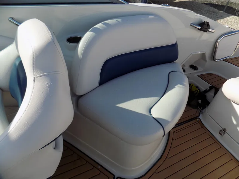 Slide: The Image of 2013 Crownline Eclipse E4 boat interior with white and blue seating on teak flooring. - 12