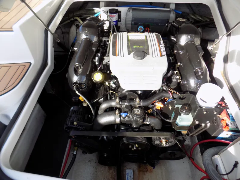 Slide: The Image of Engine compartment of a 2013 Crownline Eclipse E4 boat, showcasing detailed mechanical components. - 14