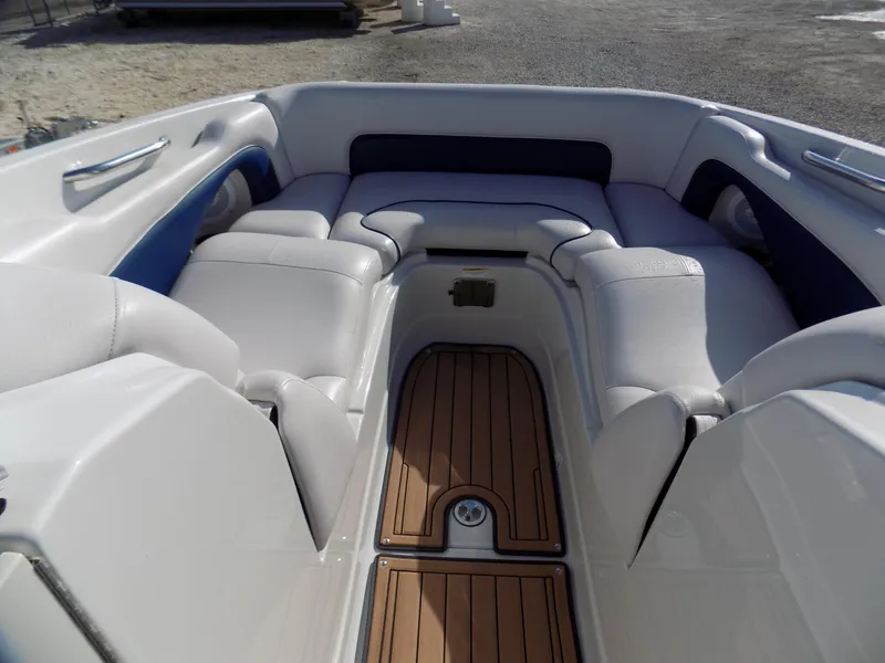 Slide: The Image of 2013 Crownline Eclipse E4 boat interior with white seating and wood flooring. - 4