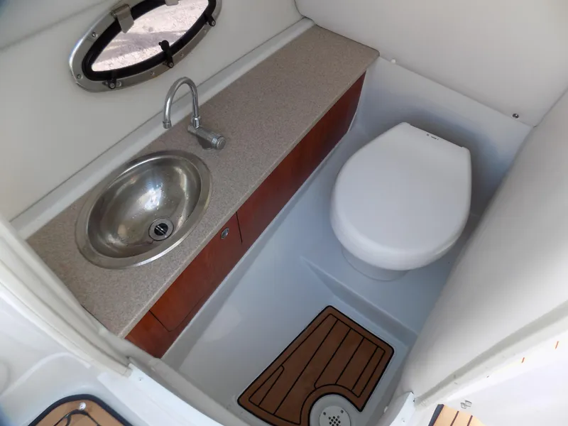 Slide: The Image of 2013 Crownline Eclipse E4 boat bathroom with sink, toilet, and wooden floor mat. - 6