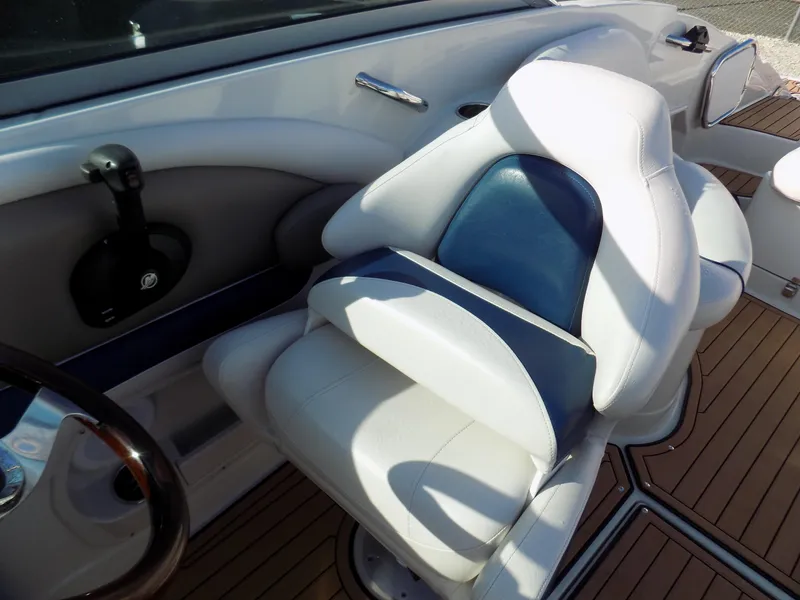 Slide: The Image of Captain's seat of 2013 Crownline Eclipse E4 boat with sleek design and wood flooring. - 8
