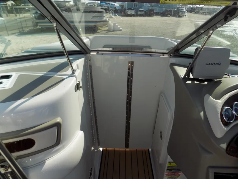 Slide: The Image of 2013 Crownline Eclipse E4 boat interior with Garmin navigation system and wood flooring. - 9