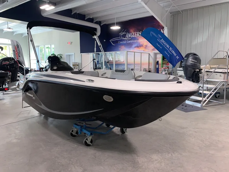 Slide: The Image of 2024 Bayliner Element M15 boat displayed in a showroom. - 0