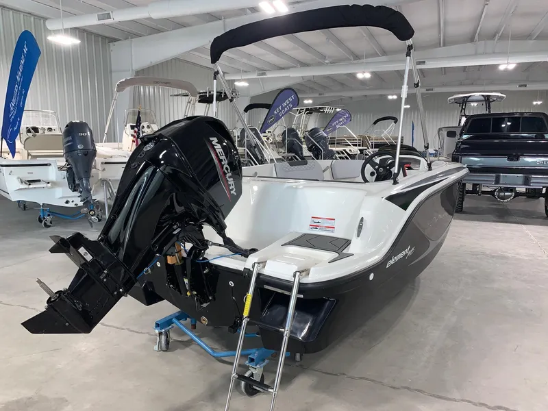 Slide: The Image of 2024 Bayliner Element M15 boat with Mercury outboard motor in showroom. - 1