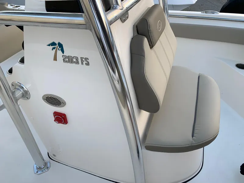 Slide: The Image of 2024 Key West 203 FS boat interior with cushioned seating and console. - 12