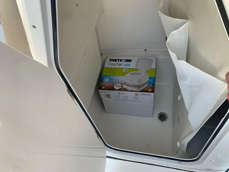 Slide: The Image of 2024 Key West 203 FS storage compartment with Thetford Porta Potti 135. - 14