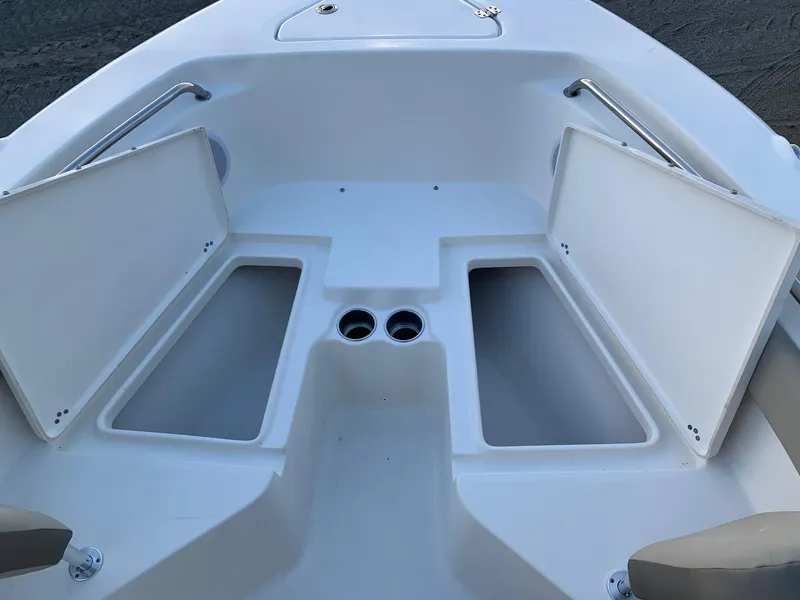 Slide: The Image of 2024 Key West 203 FS boat with open storage compartments. - 13