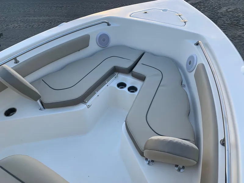 Slide: The Image of 2024 Key West 203 FS boat with cushioned seating and cup holders. - 15