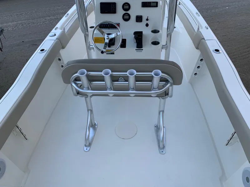 Slide: The Image of 2024 Key West 203 FS boat interior with steering console and rod holders. - 4
