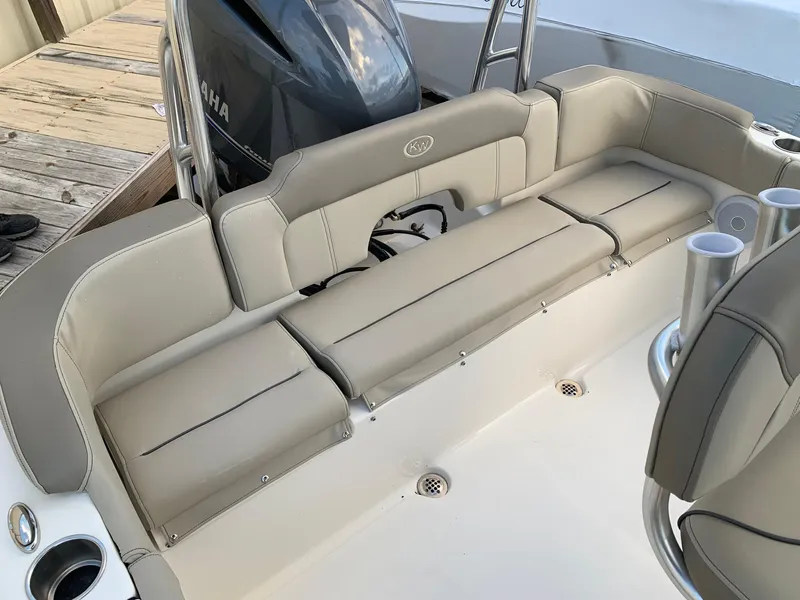 Slide: The Image of 2024 Key West 203 FS boat with beige seating and Yamaha outboard motor. - 5