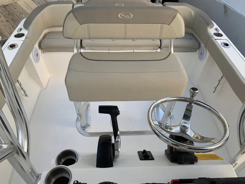 Slide: The Image of 2024 Key West 203 FS boat interior with steering wheel and seating. - 9