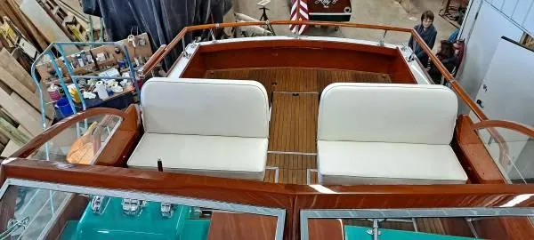 Slide: The Image of 1961 Chris-Craft Roamer boat interior with white seating and wooden deck. - 10