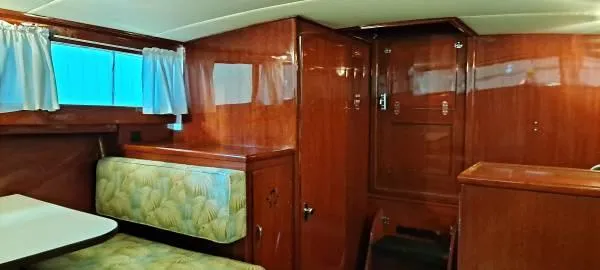 Slide: The Image of 1961 Chris-Craft Roamer interior with wood paneling and cushioned seating. - 20