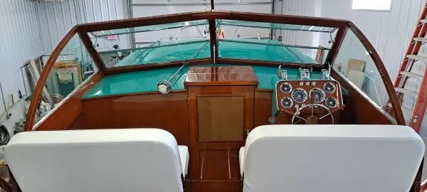 Slide: The Image of 1961 Chris-Craft Roamer boat interior with vintage dashboard and white seats. - 24