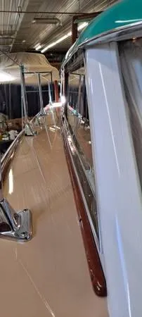 Slide: The Image of 1961 Chris-Craft Roamer boat with polished deck and classic design in a storage facility. - 26