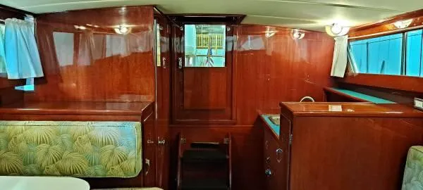 Slide: The Image of 1961 Chris-Craft Roamer interior with polished wood and vintage seating. - 27