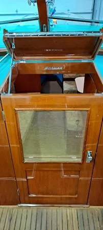 Slide: The Image of 1961 Chris-Craft Roamer boat cabin entrance with wooden finish and glass panel. - 29