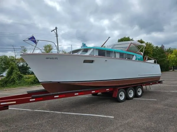 Slide: The Image of 1961 Chris-Craft Roamer boat on trailer, parked outdoors under cloudy sky. - 5