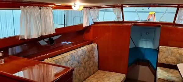 Slide: The Image of 1961 Chris-Craft Roamer interior with wood paneling and cushioned seating. - 9