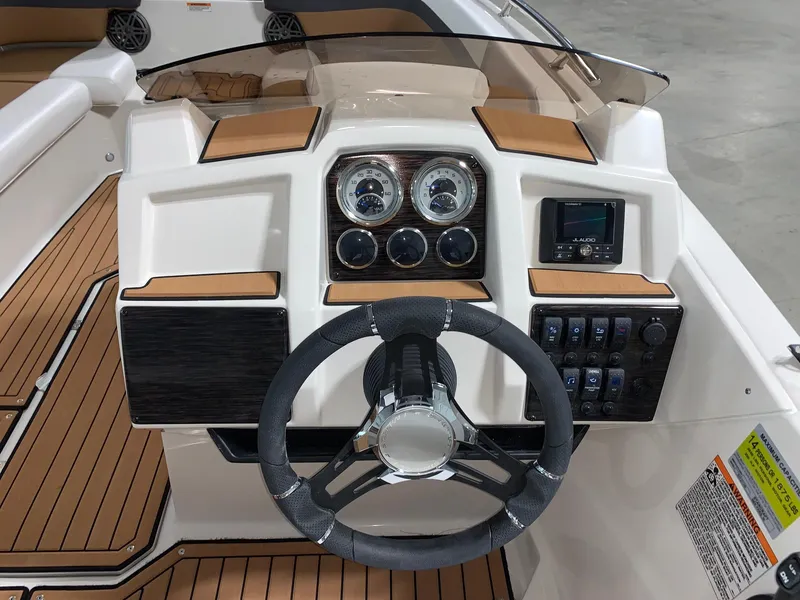 Slide: The Image of 2024 Starcraft SVX 211 boat dashboard with steering wheel and control panel. - 5
