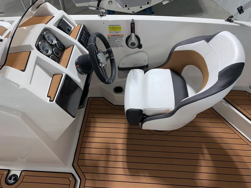 Slide: The Image of 2024 Starcraft SVX 211 boat interior with captain's chair and dashboard. - 7